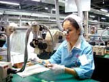worker checks circuits in Fujitsu Company